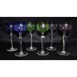 A SET OF SIX HOCK GLASSES WITH COLOURED GLASS BOWLS facet cut stems and star cut bases, 20cm high