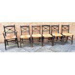 A SET OF SIX ARTS & CRAFTS CHAIRS including an armchair, the rail backs with central roundel