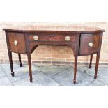 AN EDWARDIAN CROSSBANDED MAHOGANY BOWFRONT SIDEBOARD the central drawer flanked by cupboard and