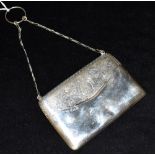 A SILVER CARD CASE Designed as a ladies bag on a chain of plain form with engraved foliate scroll to