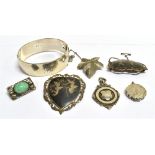 A COLLECTION OF JEWELLERY Comprising a silver half patterned bangle; three silver brooches; a marked
