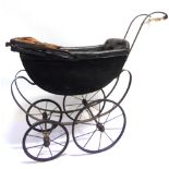 A DOLL'S PRAM with a black wood body, a folding rexine hood, and a padded black interior (lacking