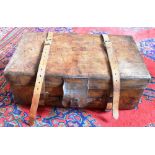 A RECTANGULAR LEATHER TRUNK by Army and Navy, London, with pair of leather straps, brass corner,
