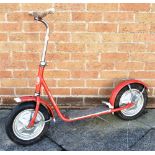 AN MW CHILD'S SCOOTER circa 1960s, red, with a rear wheel brake and folding stand, overall 112cm