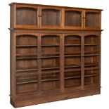 A LARGE OAK GLAZED BOOKCASE the upper section with two pairs of glazed doors, above blind fret