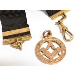 A 9CT ROSE GOLD MASONIC PENDANT PIECE Of open work design featuring the square and compass symbol,