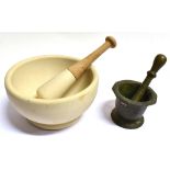 A BRONZE PESTLE AND MORTAR the mortar 11.5cm diameter, together with a ceramic mortar and pestle