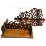 A WALNUT OPEN FRET CARVED FOLDING BOOK STAND 39cm wide; and a mahogany two tier corner shelf with