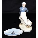 A ROYAL COPENHAGEN FIGURE OF A GIRL WTIH GOOSE model 528, 18cm high, and a Royal Copenhagen shell