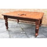 A VICTORIAN EXTENDING DINING TABLE the rectangular top with canted corners, on turned and fluted