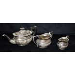 A SILVER THREE PIECE TEA SET OF MELON FORM Comprising of a teapot hallmarked Birmingham 1896 Maker
