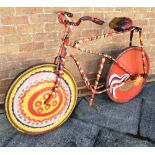 A HAWTIN CIRCUS BICYCLE painted in multi-colours, with a rise-and-fall saddle, and a rod brake to