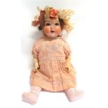 AN ARMAND MARSEILLE BISQUE SOCKET HEAD DOLL with a cropped brown wig, sleeping blue glass eyes,