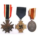 THREE GERMAN THIRD REICH MEDALS comprising a War Merit Cross, Second Class; West Wall Medal; and