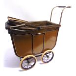 A DOLL'S PRAM the lined khaki metal body with a folding rexine hood, and a khaki padded interior,