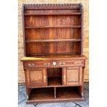 [TEMPERANCE INTEREST]. A VICTORIAN OAK DRESSER the upper section with three graduated shelves