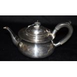 A GEORGE V SILVER TEAPOT of plain form with ebonised handle and knob Hallmarked London 1924 Weight