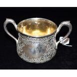 A VICTORIAN SILVER TWO HANDLED CUP The cup with an engraved foliate pattern, one blank cartouche,