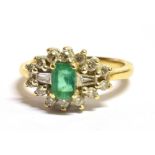 AN 18CT GOLD, EMERALD AND DIAMOND CLUSTER RING The step cut Emerald measuring 0.7cm by 0.5cm and