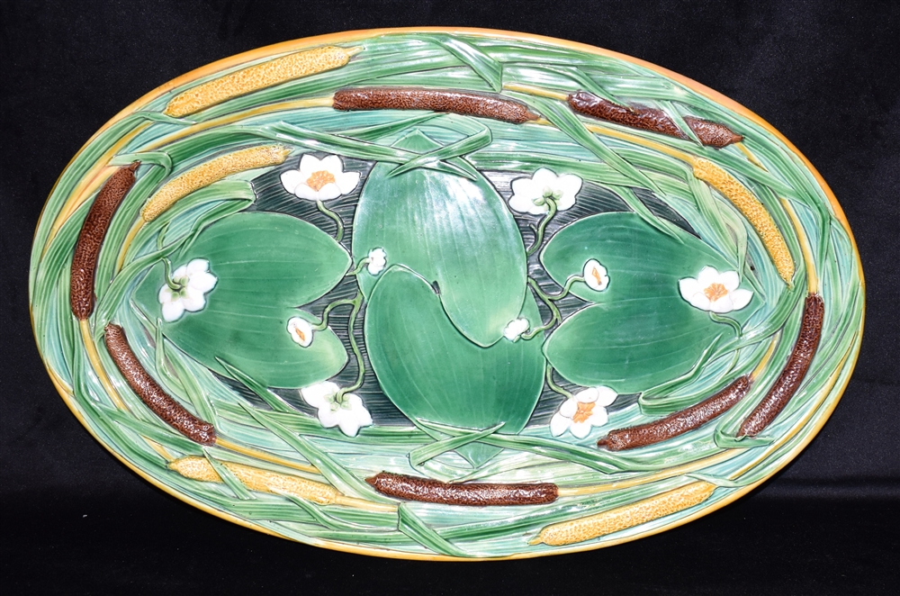 A MINTON MAJOLICA MEAT DISH relief decorated with bullrushes and waterlillies, 61cm wide,