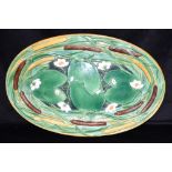 A MINTON MAJOLICA MEAT DISH relief decorated with bullrushes and waterlillies, 61cm wide,
