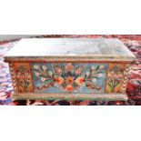 A CONTINENTAL POLYCHROME PAINTED PINE BOX with candle box to interior, 65cm wide 34cm deep 26cm high