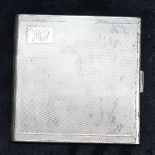 A SILVER CIGARETTE CASE of engine turned pattern with a monogrammed cartouche and hallmarked for