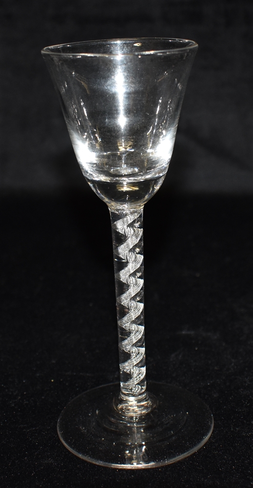 AN 18TH CENTURY STYLE WINE GLASS with funnel shaped bowl, air twist stem and conical foot, 17cm high