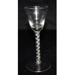 AN 18TH CENTURY STYLE WINE GLASS with funnel shaped bowl, air twist stem and conical foot, 17cm high