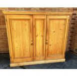 A LARGE PINE CABINET with two doors opening to reveal three fitted shelves H 148cm x W 167cm x D