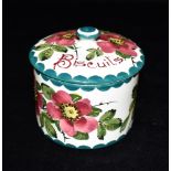 A WEMYSS WARE BISCUIT BARREL AND COVER of cylindrical form, painted with dog roses, painted to