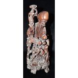 A CHINESE CARVED HARDWOOD FIGURE OF SHAO LAO holding staff, with attendant stork and child, 36cm