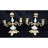 A PAIR OF CONTINENTAL GILT METAL MOUNTED TWO LIGHT CANDLESTICKS the Sevres style porcelain bodies