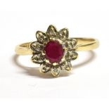 A 9CT GOLD, RUBY AND DIAMOND FLOWER HEAD RING The faceted oval ruby measuring approx. 0.5cm by 0.4cm
