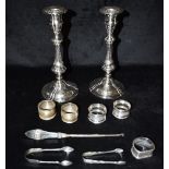 A COLLECTION OF SILVER together with a pair of plated candlesticks, the silver comprising five