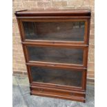 A THREE TIER OAK GLOBE WERNICKE SECTIONAL BOOKCASE with drawer to base, 87vm wide 31cm deep 124cm
