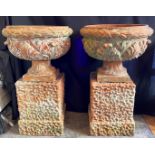 A LARGE PAIR OF LATE VICTORIAN/EARLY 20TH CENTURY TERRACOTTA URNS ON STANDS the urns 49cm high, 62cm