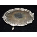 A GEORGE III SILVER TRAY On three taloned feet with scallop and ball patterned border Hallmarked for