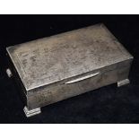 A SILVER BOX ON FOUR SQUARE FEET with engine turned design to the lid and plain sides, inlaid with