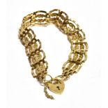 A 9CT GOLD HEART PADLOCK Four gate fancy link bracelet with safety chain, the padlock hallmarked for