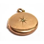 AN EARLY 20TH CENTURY DIAMOND SET CIRCULAR LOCKET the locket of rose coloured metal with rubbed