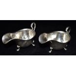 A PAIR OF SILVER SAUCE BOATS of plain form with scroll handle, hallmarked for Birmingham, date