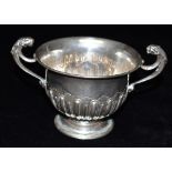 A LATE VICTORIAN TWO HANDLED SILVER BOWL the bowl with animal figural handles, an embossed pattern