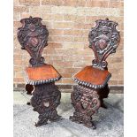 PAIR OF OAK HALL CHAIRS with shield decoration, H 97cm