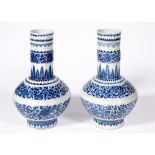 A LARGE PAIR OF CHINESE BOTTLE VASES the neck and angled globular body decorated with bands of