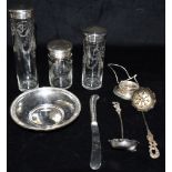 A COLLECTION OF SILVER ITEMS Comprising three silver topped glass jars, A silver coin or bon bon