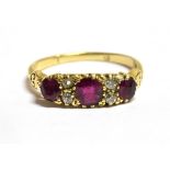 A DIAMOND AND RUBY DRESS RING The ring set three Rubies spaced with a pair of small diamonds each