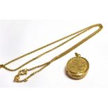 A 9CT GOLD LOCKET together with a 9ct gold Italy fine link chain, The locket with foliate engraved