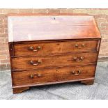 A GEORGE III FRUITWOOD BUREAU with fitted interior above three long drawers on bracket feet, 121cm