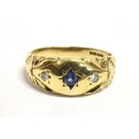 A 9ct GOLD SAPPHIRE AND DIAMOND GYPSY RING The ring set with a central star set blue sapphire with a